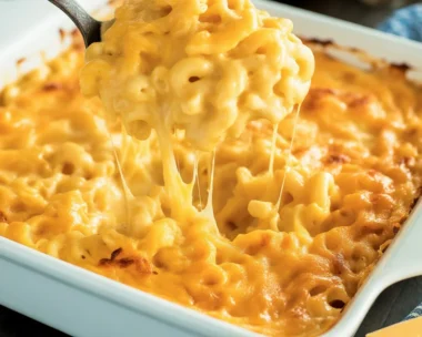 A delicious serving of classic mac and cheese with gooey cheese and crunchy top.