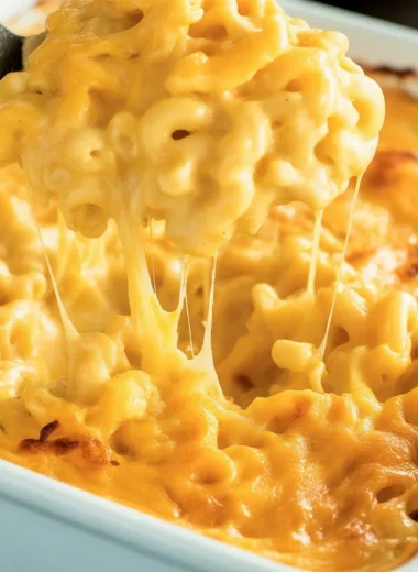 A delicious serving of classic mac and cheese with gooey cheese and crunchy top.