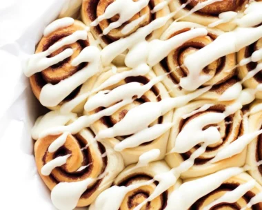 Fluffy 1 Hour Cinnamon Rolls with cream cheese icing on a baking tray.