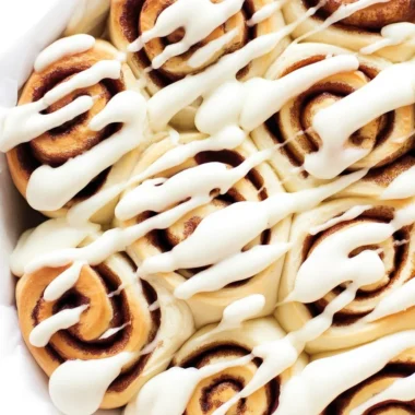 Fluffy 1 Hour Cinnamon Rolls with cream cheese icing on a baking tray.