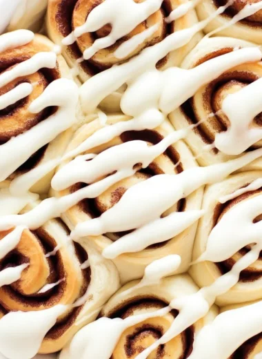 Fluffy 1 Hour Cinnamon Rolls with cream cheese icing on a baking tray.