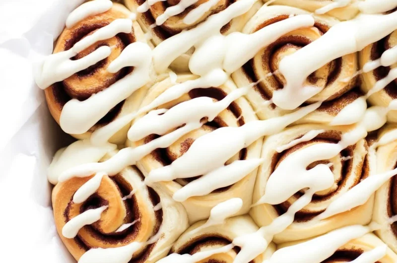 Fluffy 1 Hour Cinnamon Rolls with cream cheese icing on a baking tray.