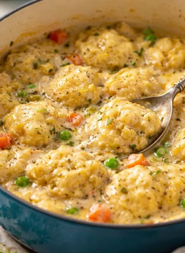A hearty bowl of Creamy Chicken and Dumplings topped with fluffy dumplings in creamy broth.