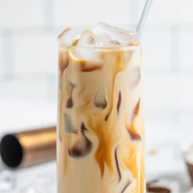 Salted Caramel White Russian cocktail garnished with caramel sauce and salt.