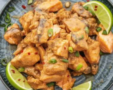 Bang Bang Salmon served with creamy sauce and fresh vegetables on a plate.