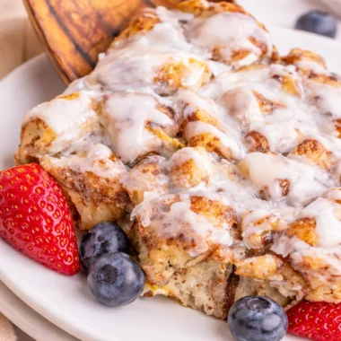 Easy Cinnamon Roll Casserole with store-bought rolls, topped with icing and maple syrup.