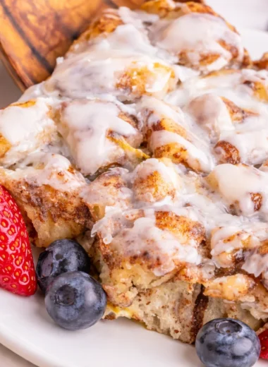Easy Cinnamon Roll Casserole with store-bought rolls, topped with icing and maple syrup.
