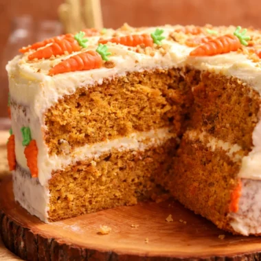 Moist Carrot Cake with Cream Cheese Frosting topped with walnuts and spices