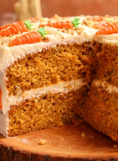 Moist Carrot Cake with Cream Cheese Frosting topped with walnuts and spices