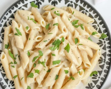 One-Pot Creamy Garlic Parmesan Pasta in a skillet, garnished with parsley.