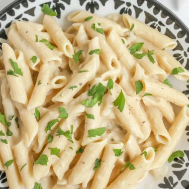 Quick and Easy One-Pot Creamy Garlic Parmesan Pasta recipe 38 One-Pot Creamy Garlic Parmesan Pasta in a skillet, garnished with parsley.