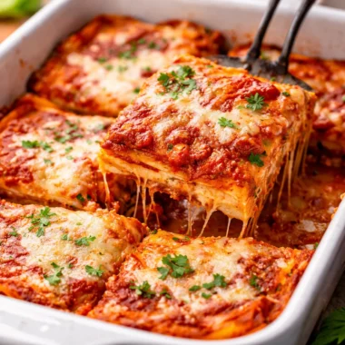 Delicious homemade lasagna layered with pasta, marinara sauce, ricotta, and mozzarella.