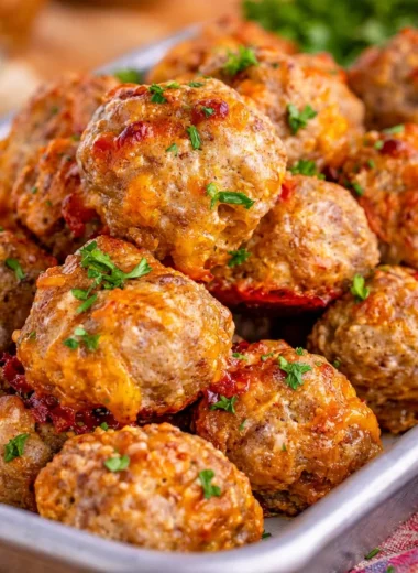 Plate of spicy Mexican donkey balls with jalapeños and melted cheese.