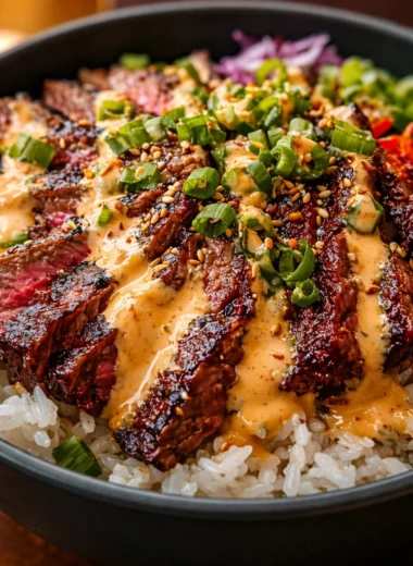 Korean BBQ Steak Rice Bowls with Spicy Cream Sauce featuring marinated beef and fresh veggies.