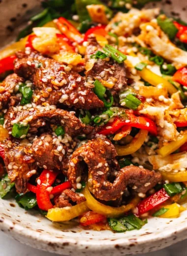 Delicious Korean BBQ Steak Bowls with marinated beef and spicy sesame dressing.