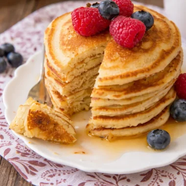 Fluffy and delicious award winning pancake recipe served with fresh fruit and syrup.