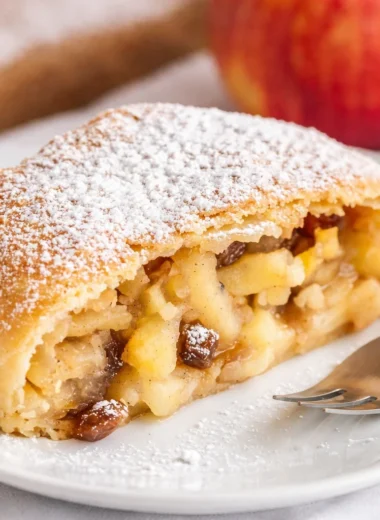 Delicious homemade German Apple Strudel (Apfelstrudel) with spiced apple filling.