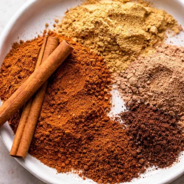 Homemade pumpkin pie spice mix with cinnamon, ginger, nutmeg, and cloves.