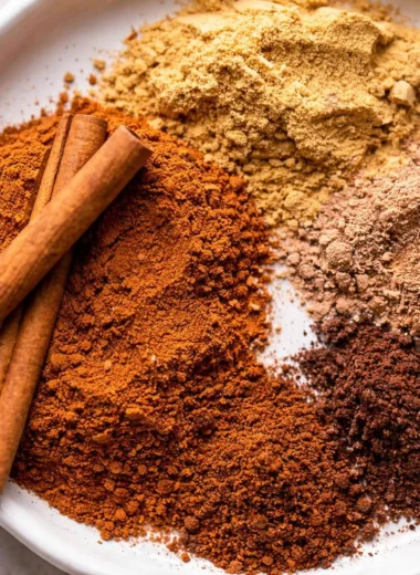 Homemade pumpkin pie spice mix with cinnamon, ginger, nutmeg, and cloves.