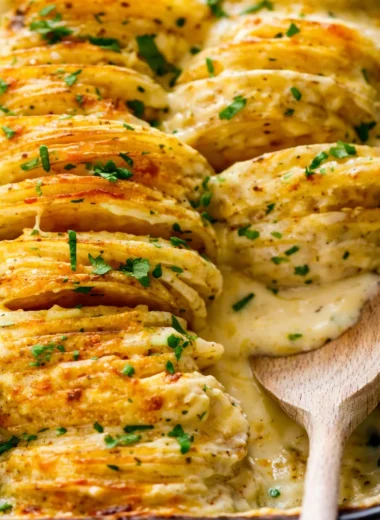 Delicious cheesy scalloped potatoes baked in creamy cheese sauce.