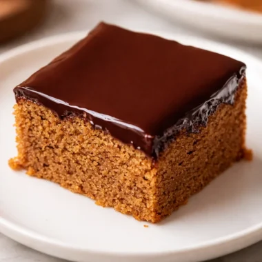 Traditional German Honey Cake (Honigkuchen) topped with chocolate glaze and apricot jam.