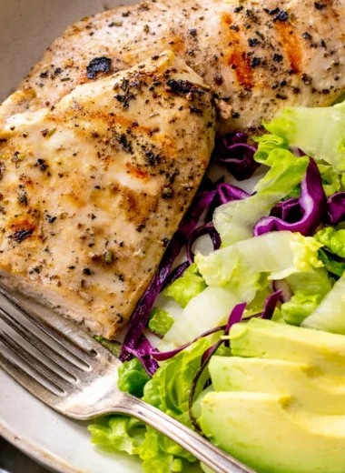 Grilled thin chicken breast cutlets cooked to perfection on a BBQ grill.