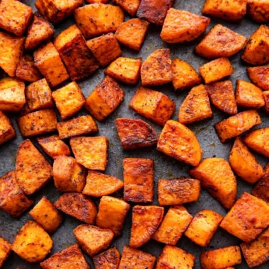 Oven roasted sweet potatoes in a baking dish, perfectly caramelized and tender.