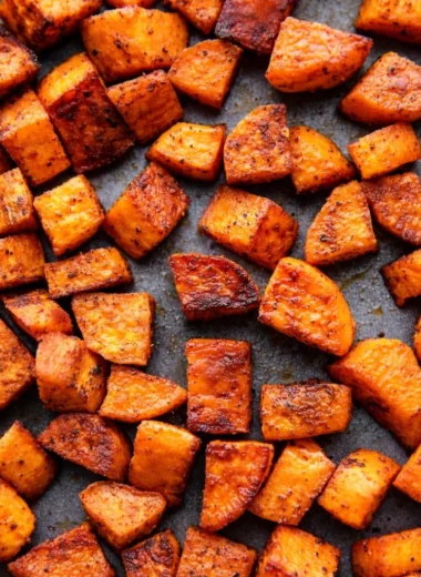 Oven roasted sweet potatoes in a baking dish, perfectly caramelized and tender.