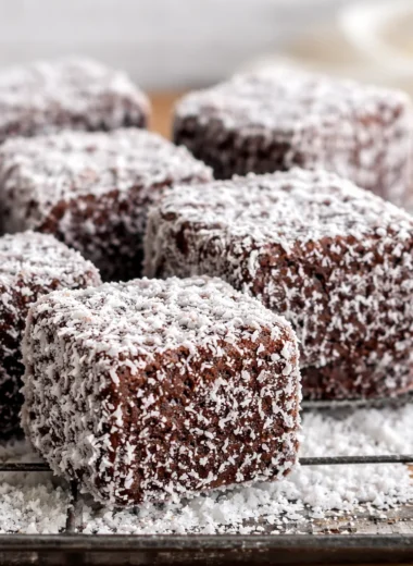 Delicious homemade lamingtons made with fluffy sponge cake, chocolate glaze, and coconut.