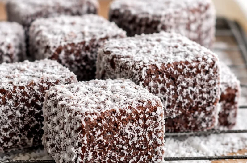 Delicious homemade lamingtons made with fluffy sponge cake, chocolate glaze, and coconut.