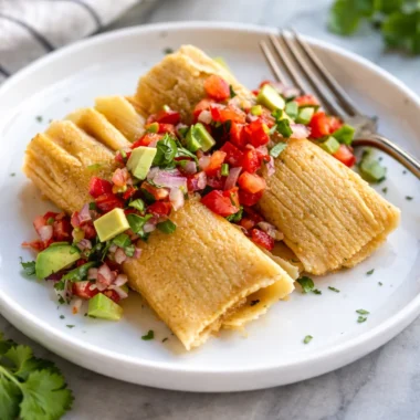 Delicious homemade Mexican Tamales filled with pork and red chile sauce.