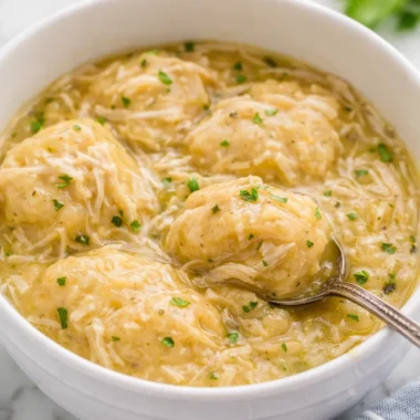 Bowl of creamy Crockpot Chicken and Dumplings with tender chicken and fluffy dumplings.