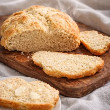 Plate of freshly baked Australian damper bread served with butter.