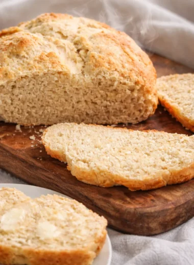 Plate of freshly baked Australian damper bread served with butter.