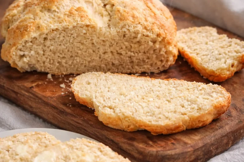 Plate of freshly baked Australian damper bread served with butter.