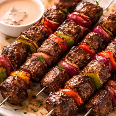 Juicy Australian beef skewers on the grill, served with fresh vegetables.