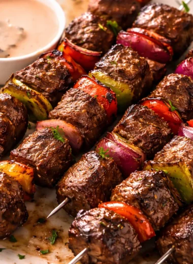Juicy Australian beef skewers on the grill, served with fresh vegetables.