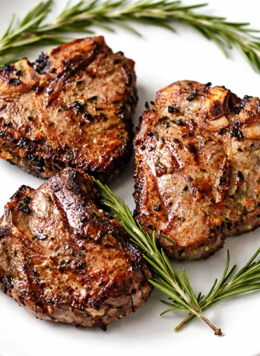 Deliciously grilled Australian lamb chops garnished with rosemary and garlic.