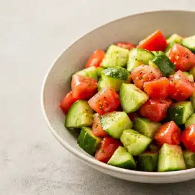 Crisp Cucumber Tomato Salad 29 Crisp cucumber tomato salad with fresh ingredients in a bowl.