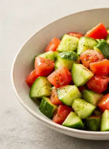 Crisp cucumber tomato salad with fresh ingredients in a bowl.