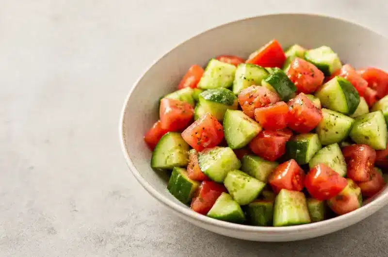 Crisp cucumber tomato salad with fresh ingredients in a bowl.