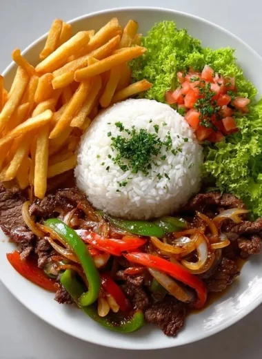 Crispy beef stir-fry with rice, fries, and colorful salad on a plate.