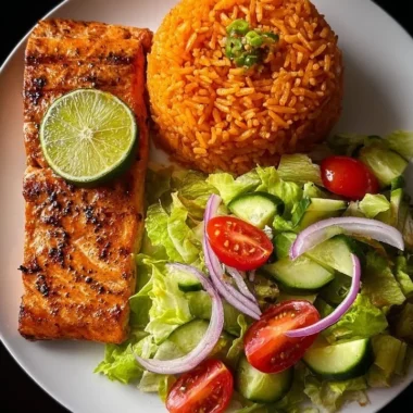 Lime-glazed salmon served with Spanish rice and a fresh garden salad.