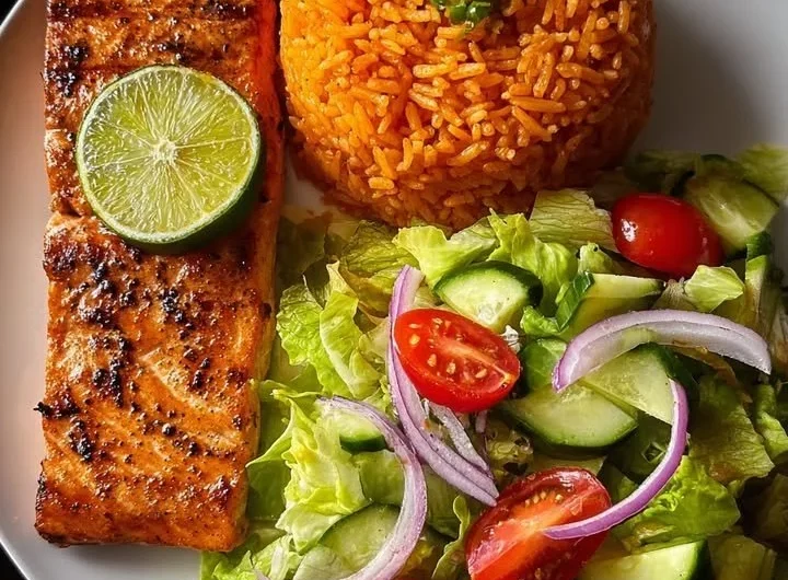Lime-glazed salmon served with Spanish rice and a fresh garden salad.
