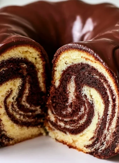 Slice of authentic German Marble Cake topped with chocolate glaze