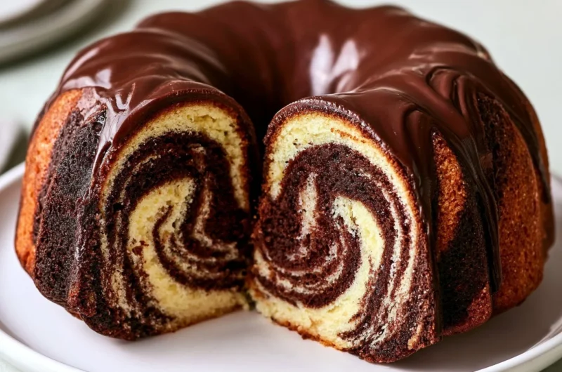 Slice of authentic German Marble Cake topped with chocolate glaze