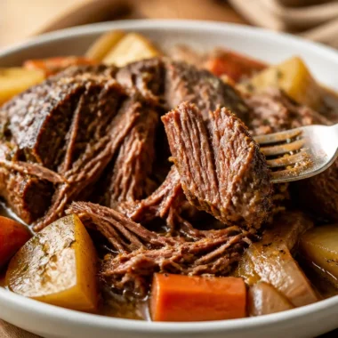 Delicious slow cooker pot roast served with vegetables on a plate