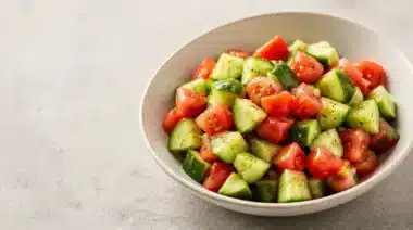 Crisp cucumber tomato salad with fresh ingredients in a bowl.