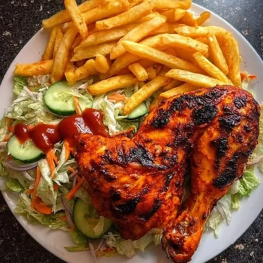 Flame-Grilled Chicken Leg Quarters with Fries & Salad 35 Flame-grilled chicken leg quarters with fries and salad on a plate