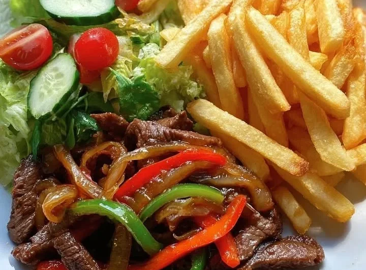 Delicious pepper steak stir-fry with crispy fries and fresh garden salad
